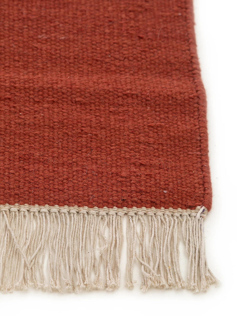 Tapis scandinave uni à franges rouge brique en laine 120x170 cm