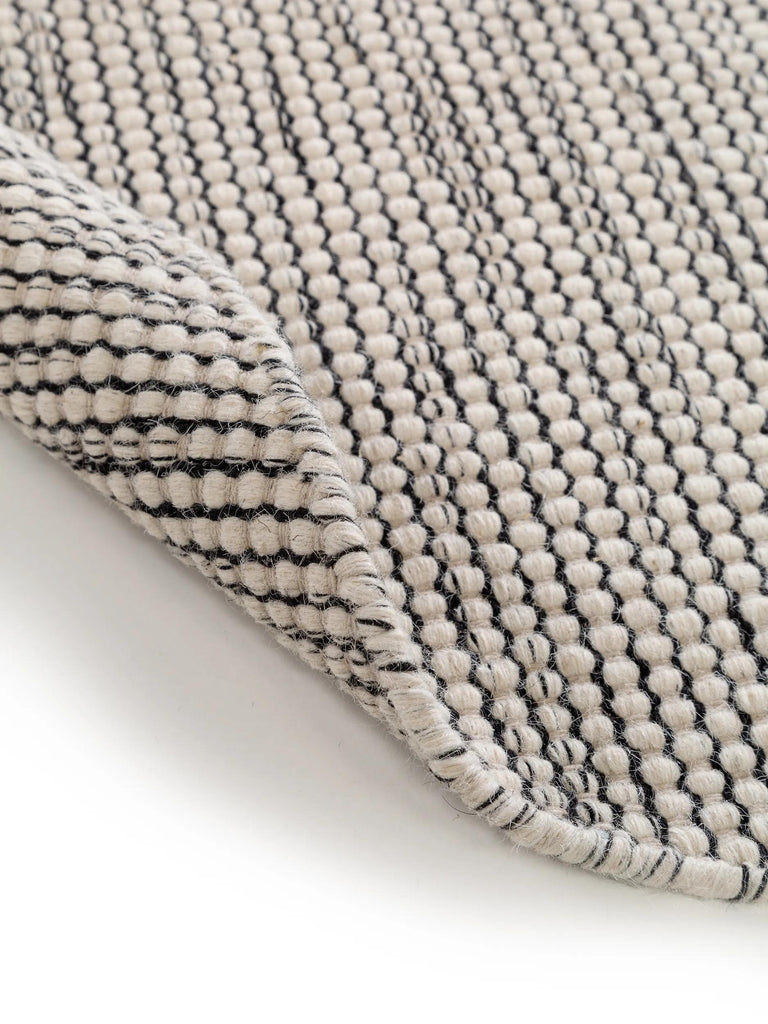 Tapis scandinave chiné rond beige et noir en laine 100 cm de diamètre