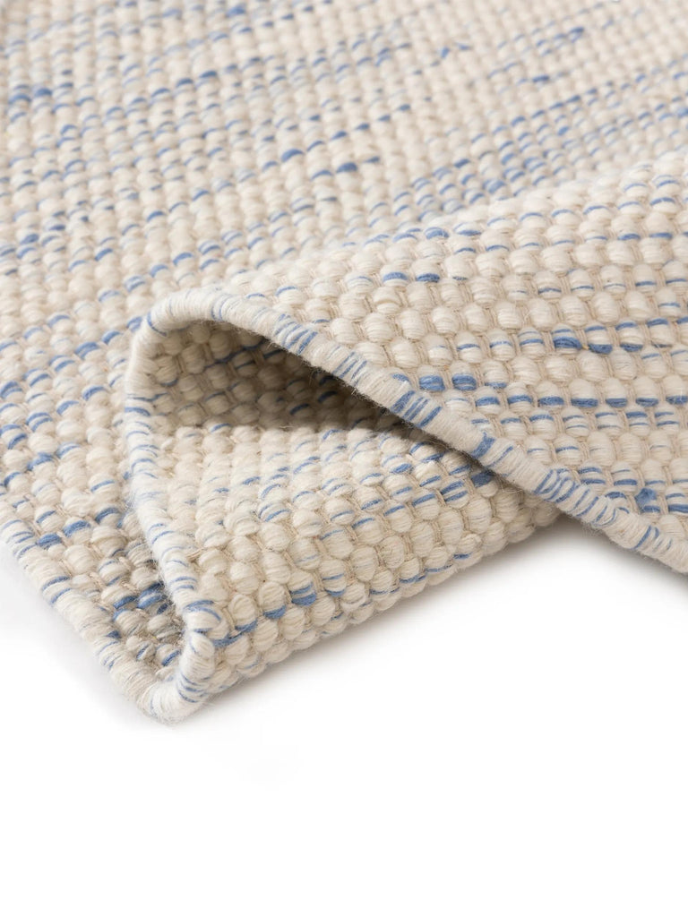 Tapis scandinave tressé rond enfant blanc et bleu en laine 100 cm de diamètre