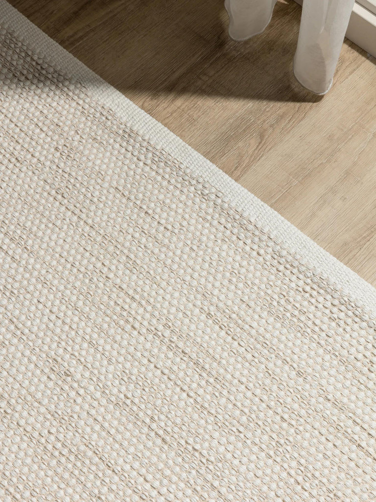 Tapis scandinave tressé en cercle crème en coton 160x230 cm