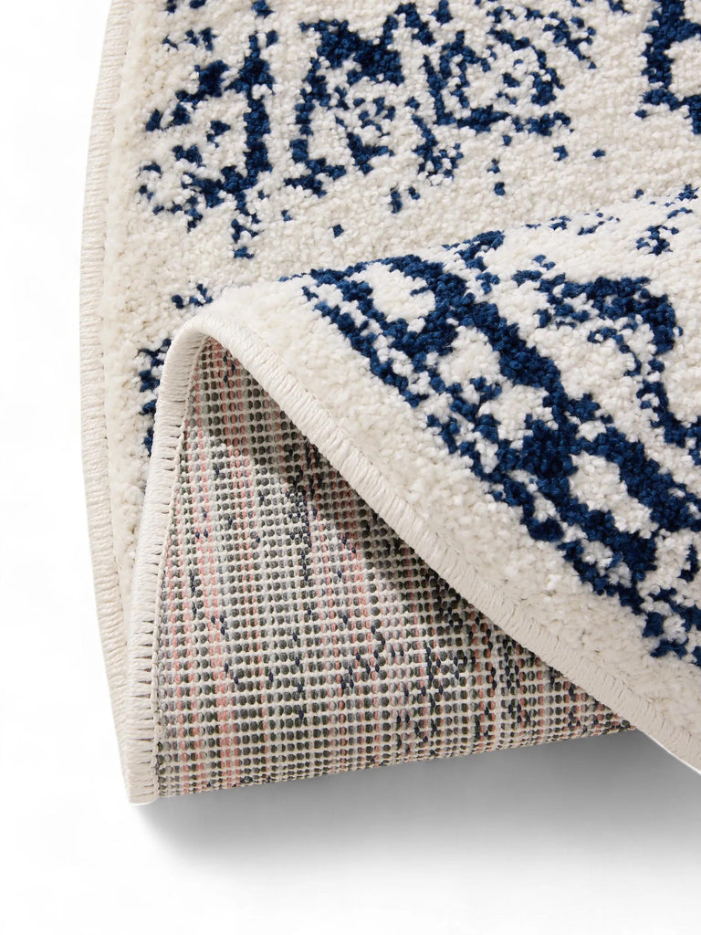 Tapis vintage motif oriental rond blanc et bleu foncé 120 cm de diamètre